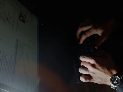hands of an anonymous individual typing in front of a screen