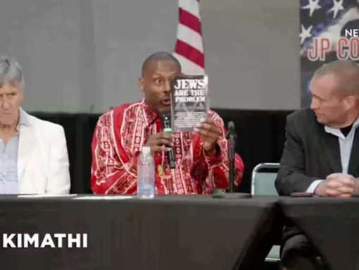 Ayo Kimathi promotes his book “Jews Are the Problem” during a panel at the JP Conference, 6/30/2024. Source: Rumble