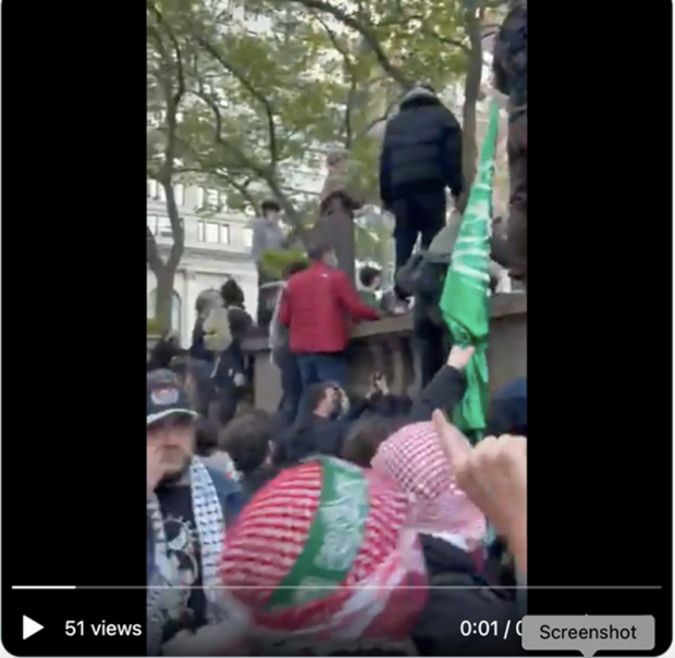 Protestors carrying a Hamas flag